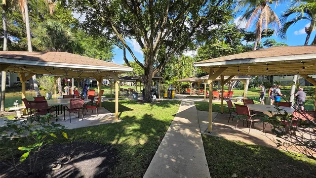 a view of a house with backyard and sitting area