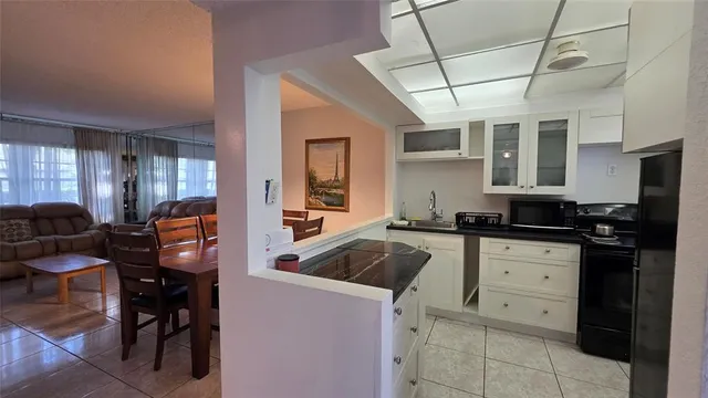 a kitchen with a sink a stove and chairs