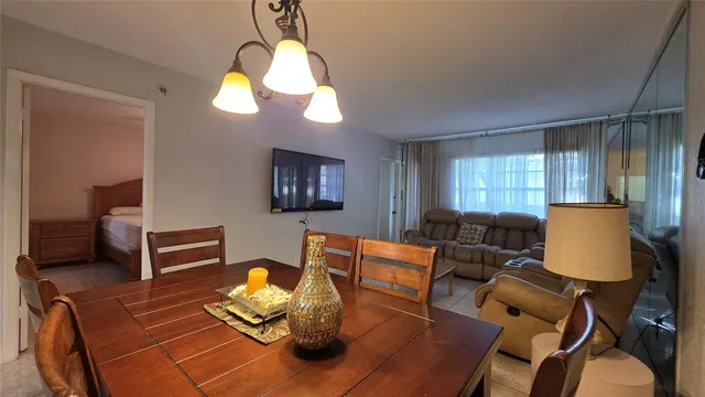 a living room with furniture a fireplace and a chandelier