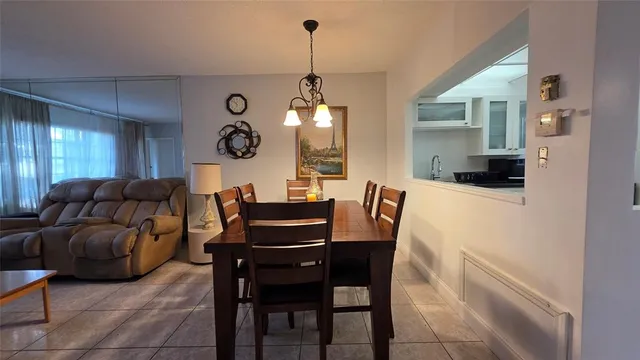 a living room with furniture a flat screen tv and a table