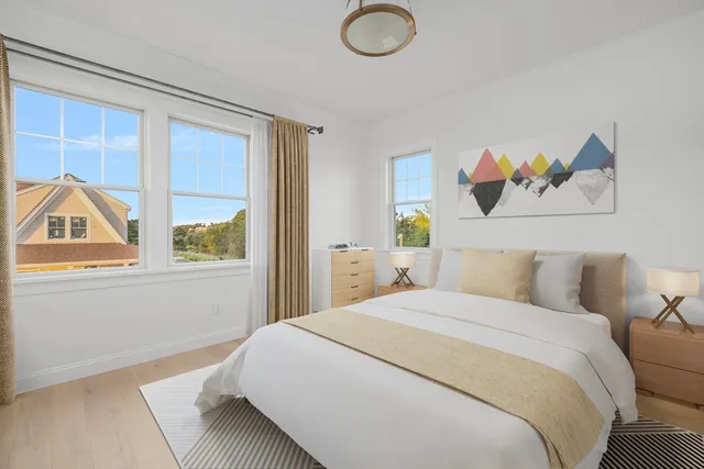 a bedroom with a bed and a painting on the wall