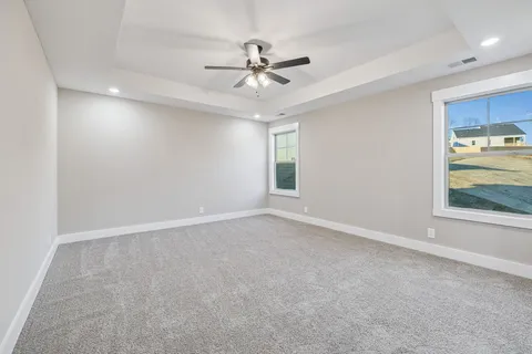 wooden floor in an empty room with a ceiling fan