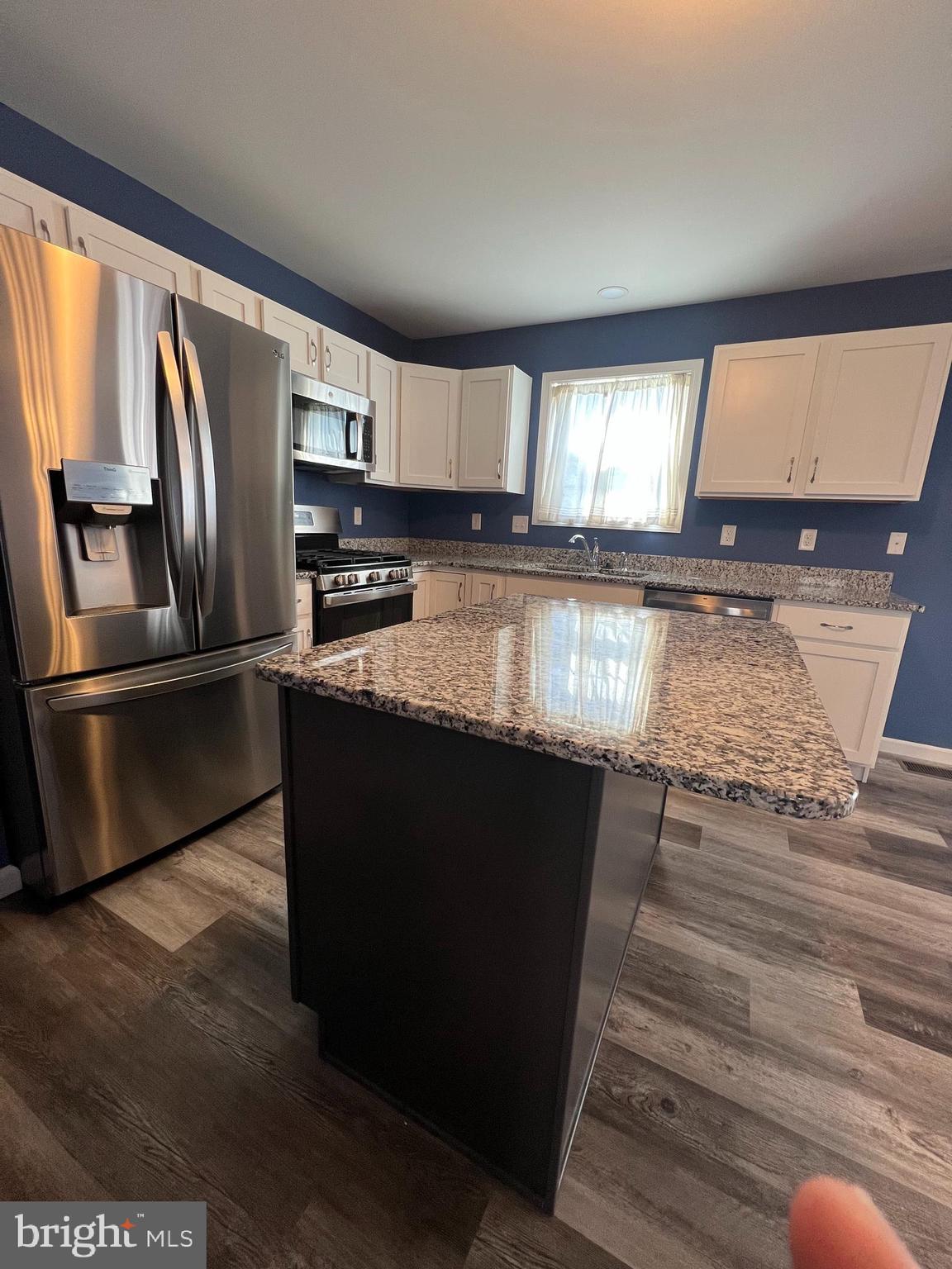 2317 Bartlett Road Harrisburg, PA 17110 - Photo 21 of 59 a kitchen with granite countertop a refrigerator and a stove top oven