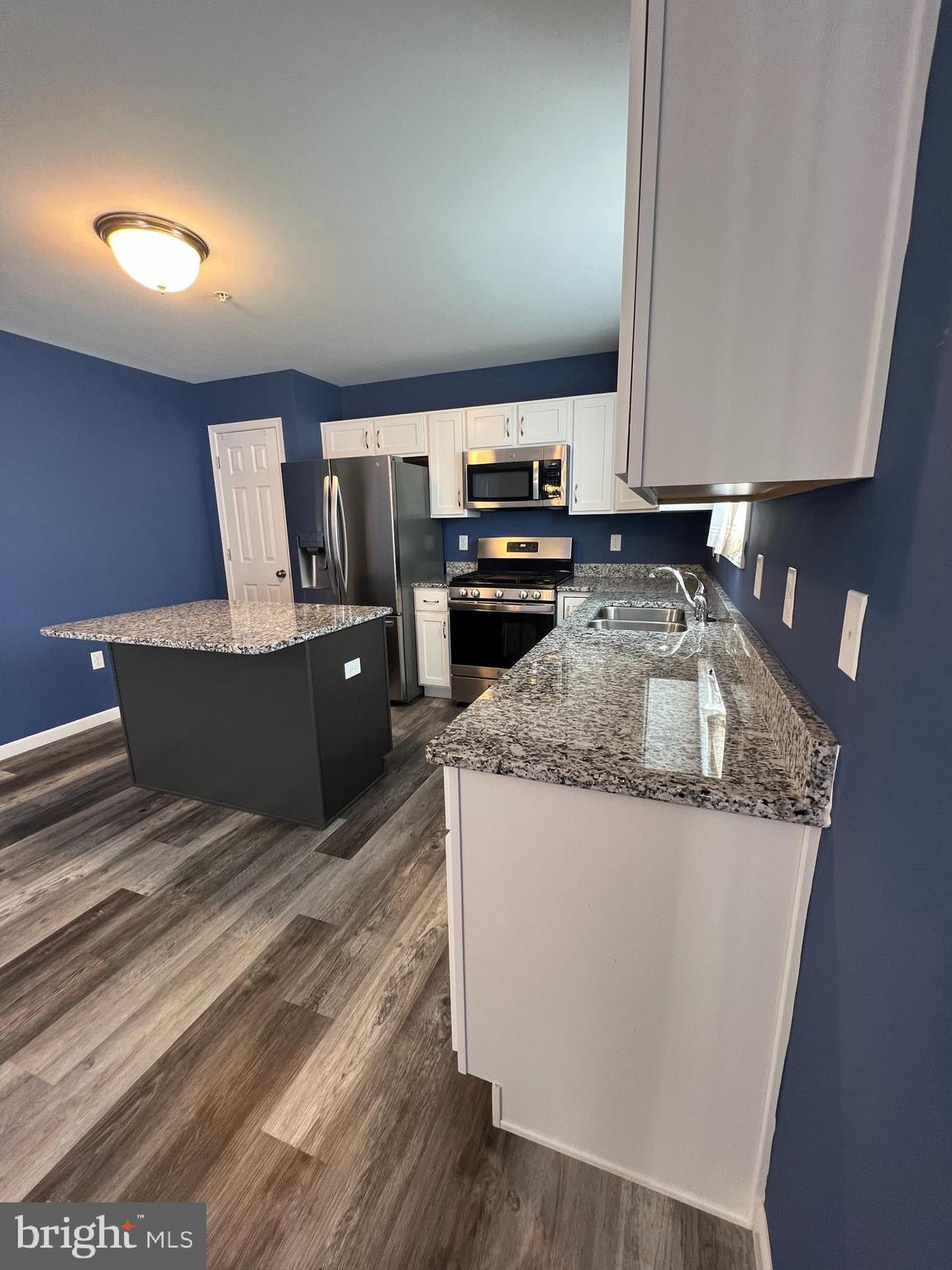 2317 Bartlett Road Harrisburg, PA 17110 - Photo 23 of 59 a kitchen with kitchen island granite countertop a sink and refrigerator
