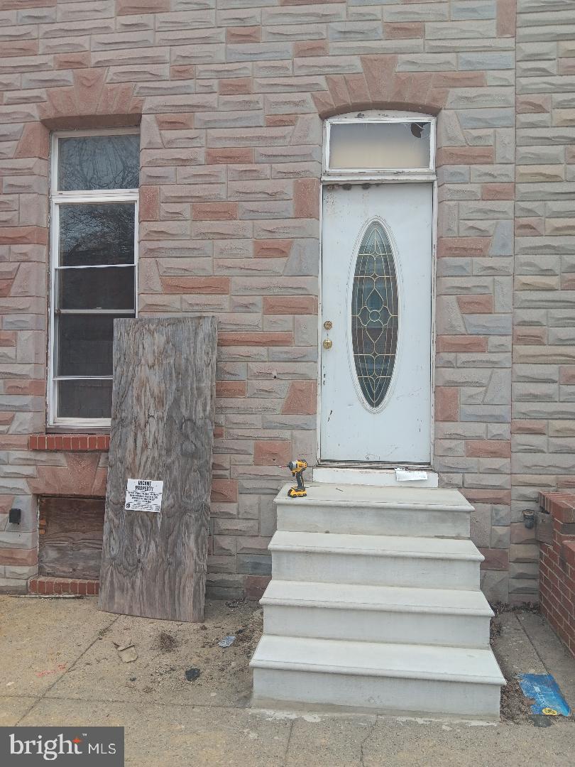 1008 East Biddle Street Baltimore, MD 21202 - Photo 1 of 12 a view of a entryway of a house with brick walls