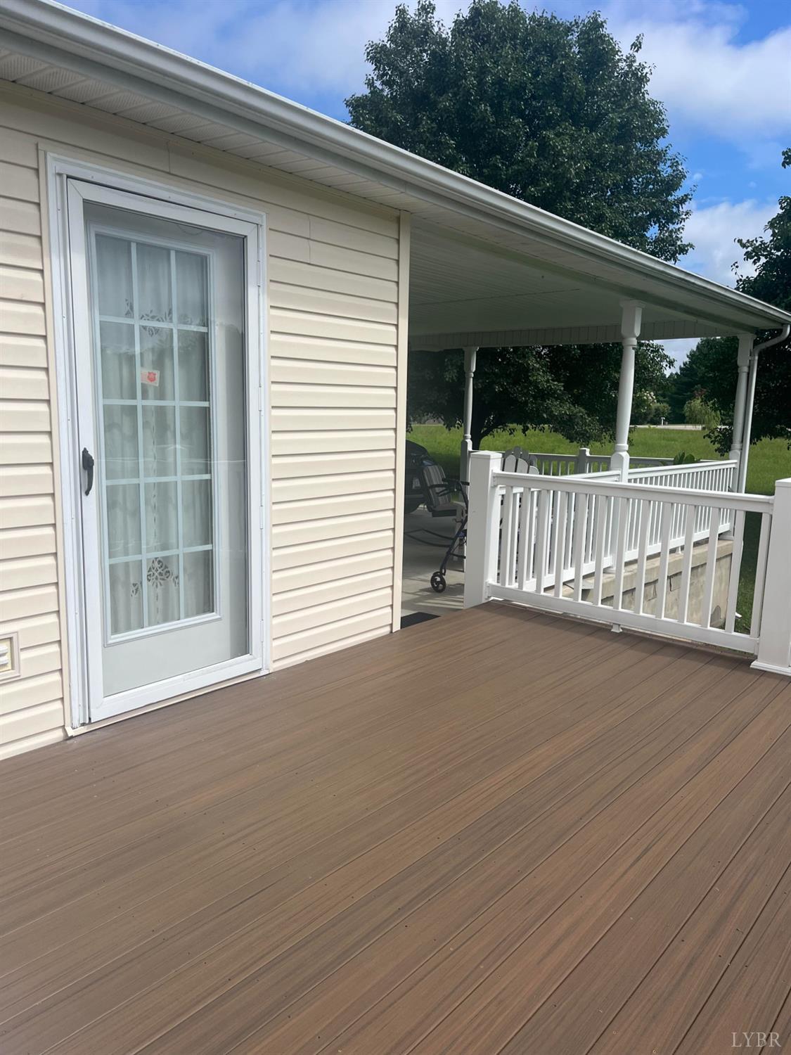 2135 Spring Garden Road Chatham, VA 24531 - Photo 16 of 18 a view of a deck with a floor to ceiling window and wooden floor