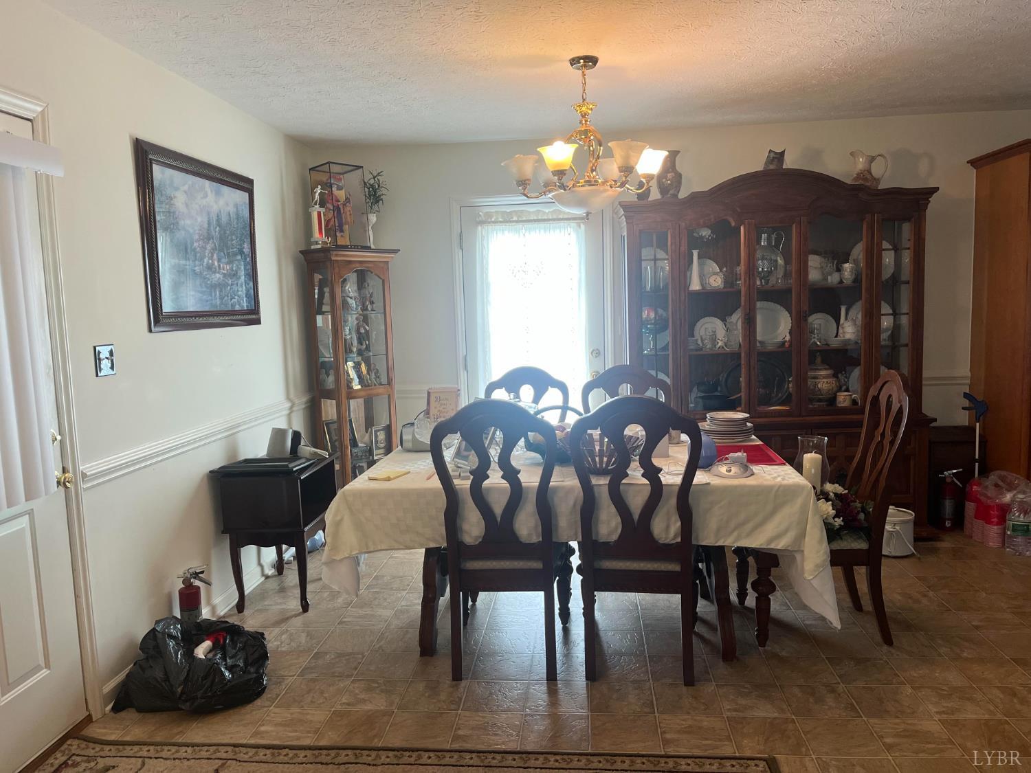 2135 Spring Garden Road Chatham, VA 24531 - Photo 4 of 18 a view of a dining room with furniture and chandelier