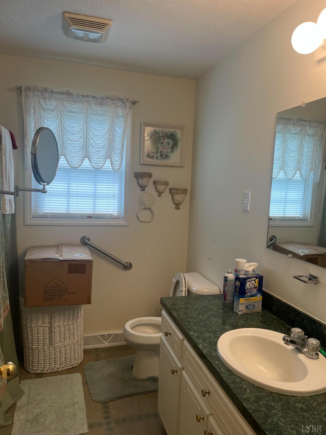 2135 Spring Garden Road Chatham, VA 24531 - Photo 10 of 18 a bathroom with a granite countertop sink and a mirror