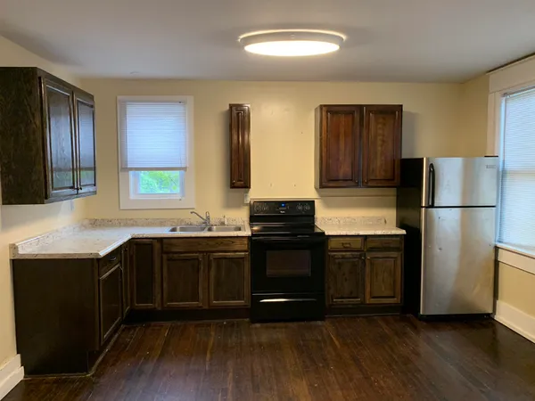 a kitchen with stainless steel appliances granite countertop a refrigerator a stove a sink and a microwave