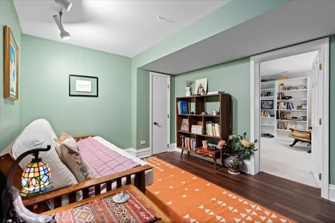 a reading room with furniture rug and window