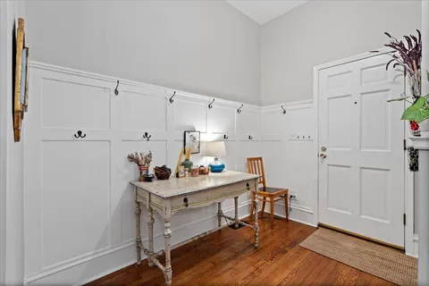 a view of a workspace with furniture and wooden floor
