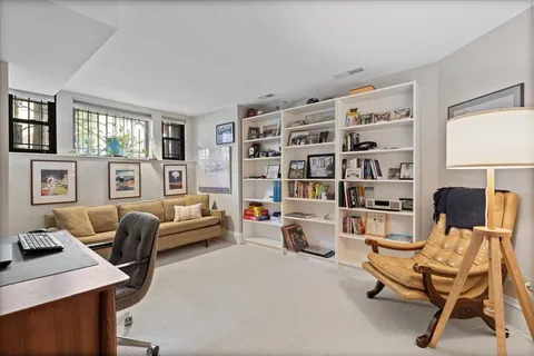 a living room with furniture and a bookshelf