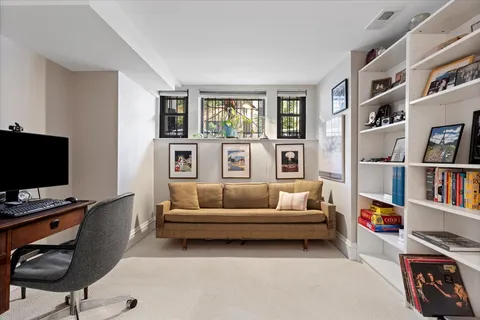 a living room with furniture and a book shelf