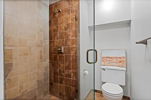 a bathroom with a toilet and a shower
