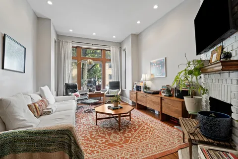 a living room with furniture fireplace and a flat screen tv