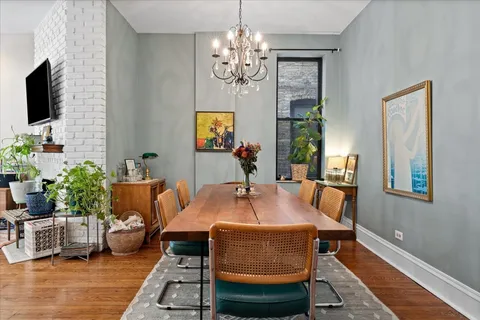 a outdoor dining space with furniture a rug and a chandelier