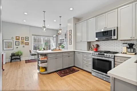 a kitchen with a sink cabinets and stainless steel appliances