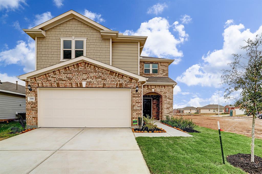 A two-car attached garage, wide driveway, brick faade, and lovely landscaping welcome you home.