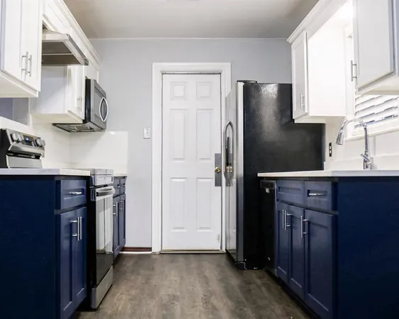 a kitchen with stainless steel appliances granite countertop a refrigerator and a sink