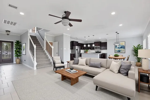 a living room with furniture and kitchen view