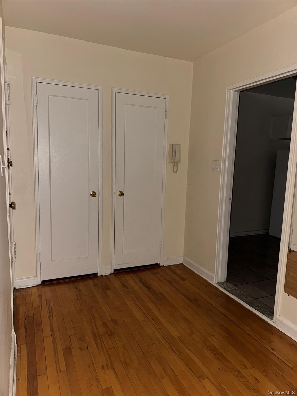 88-10 34th Avenue, Unit 2M Queens, NY 11372 - Photo 6 of 12 a view of an empty room with wooden floor and closet