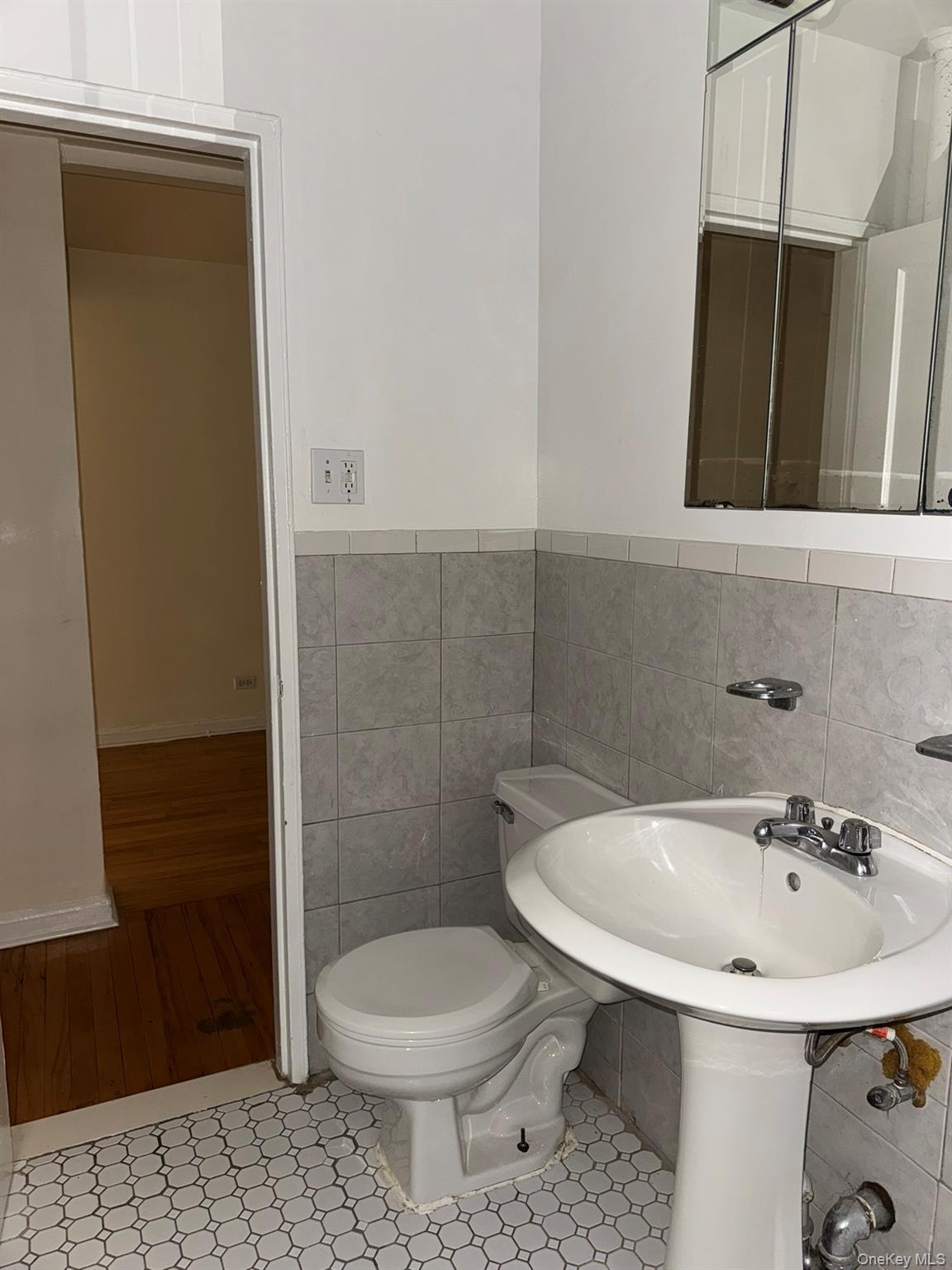 88-10 34th Avenue, Unit 2M Queens, NY 11372 - Photo 10 of 12 a bathroom with a sink and a toilet