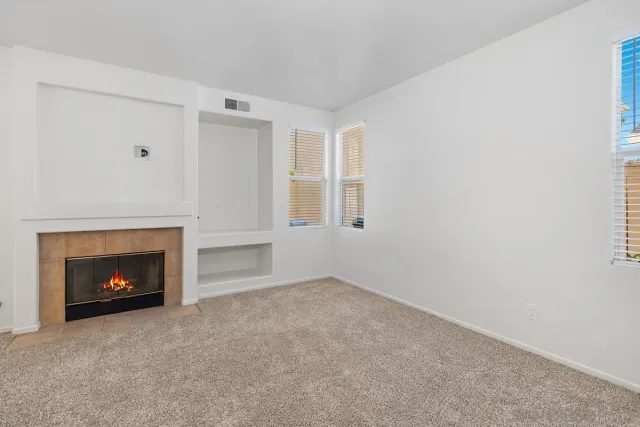 a view of an empty room with fire place