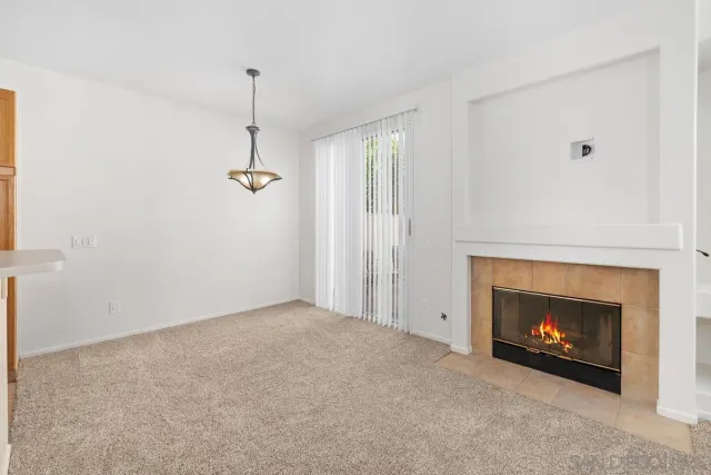 a view of an empty room with a fireplace