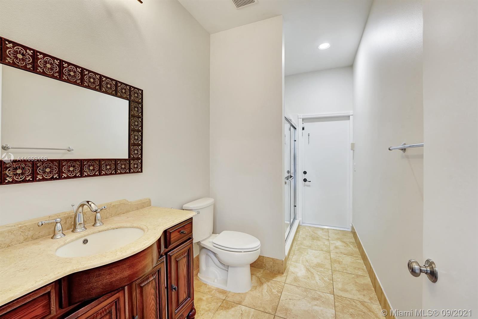 18672 Sea Turtle Lane Boca Raton, FL 33498 - Photo 11 of 44 a bathroom with a sink a toilet and shower