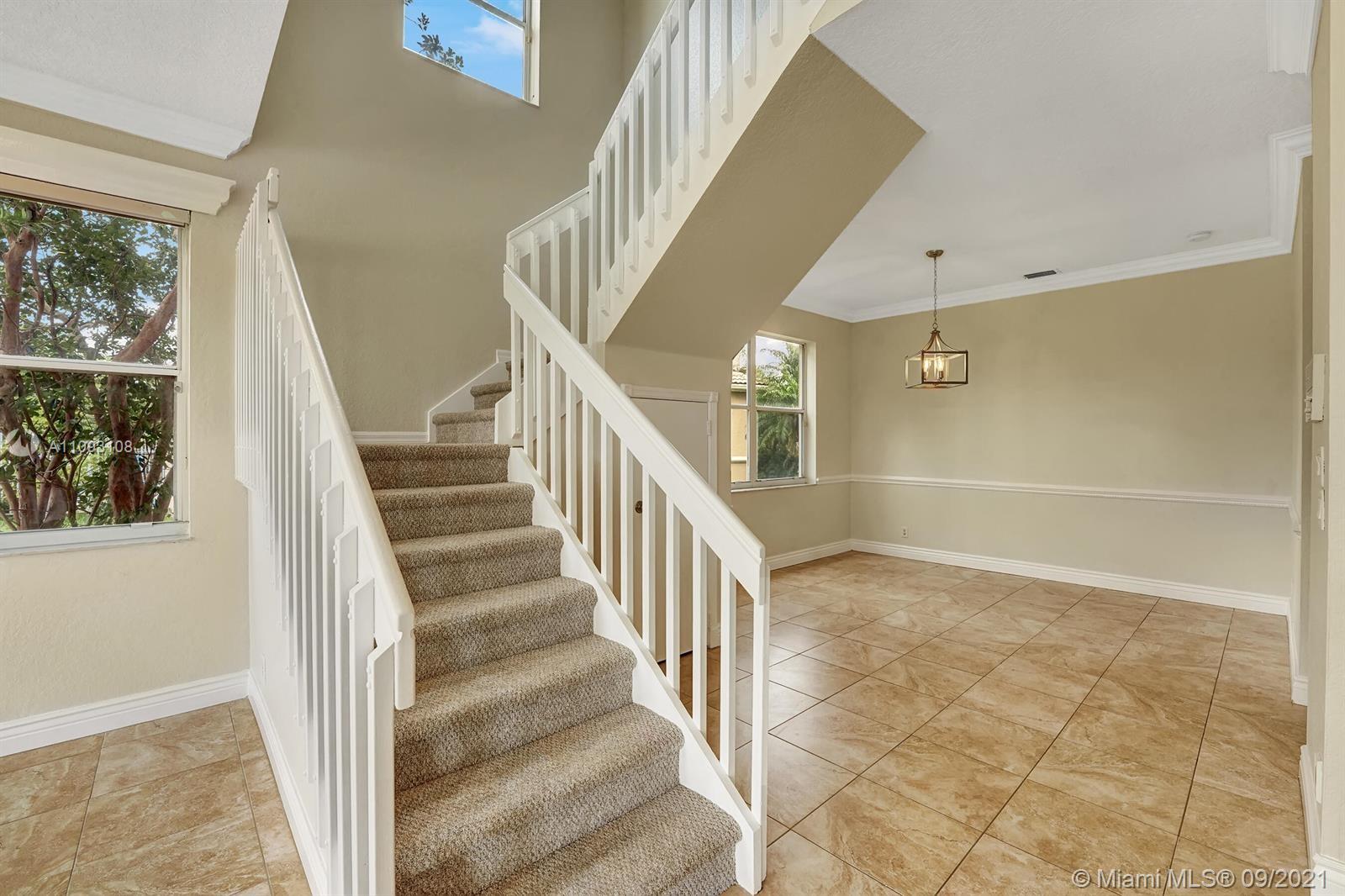 18672 Sea Turtle Lane Boca Raton, FL 33498 - Photo 13 of 44 a view of staircase with white walls and windows
