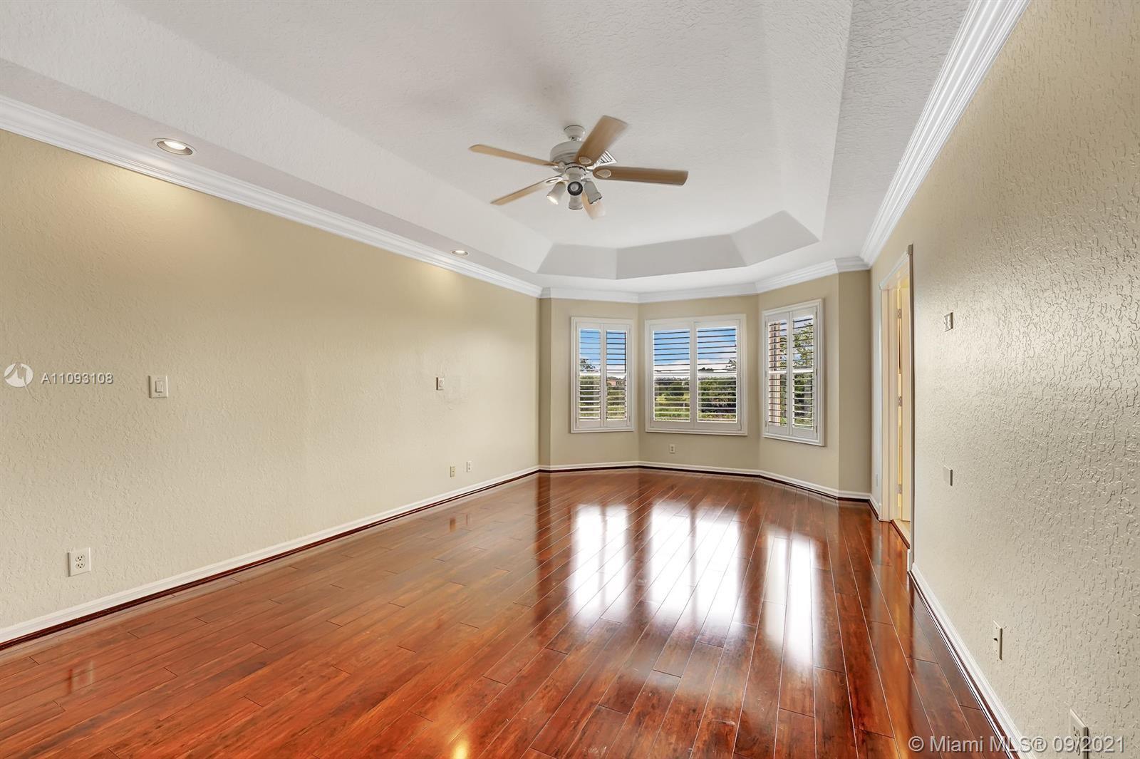18672 Sea Turtle Lane Boca Raton, FL 33498 - Photo 16 of 44 a view of an empty room with wooden floor and a window
