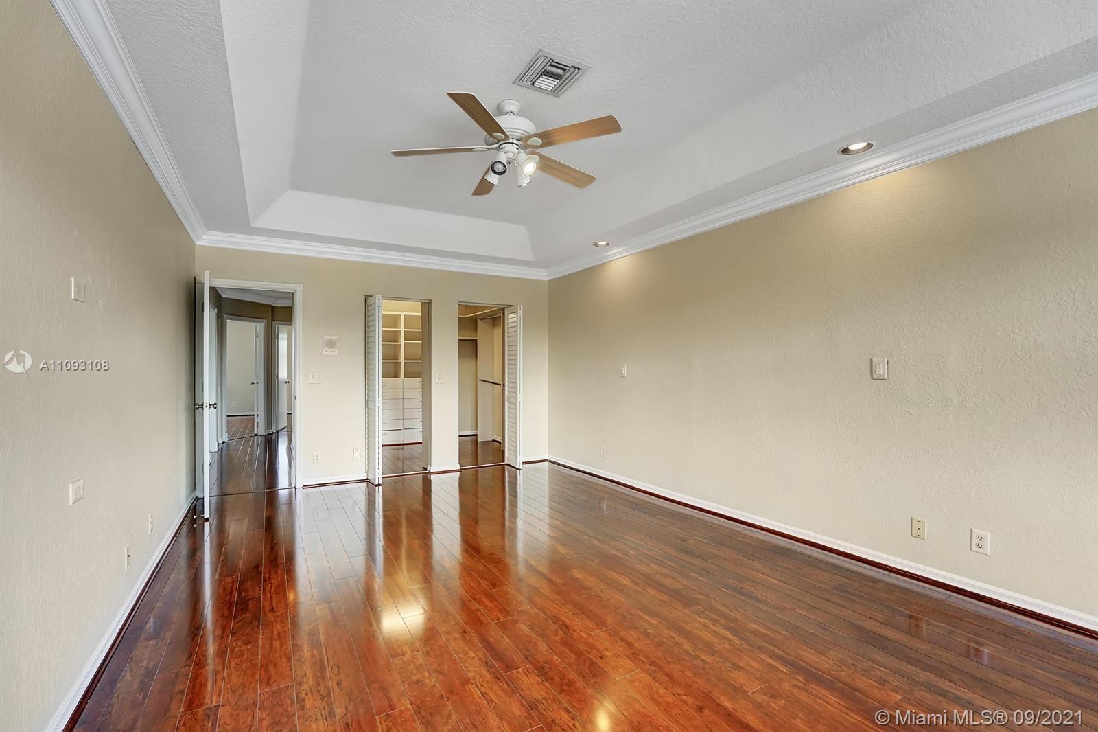 18672 Sea Turtle Lane Boca Raton, FL 33498 - Photo 17 of 44 wooden floor in an empty room with a window