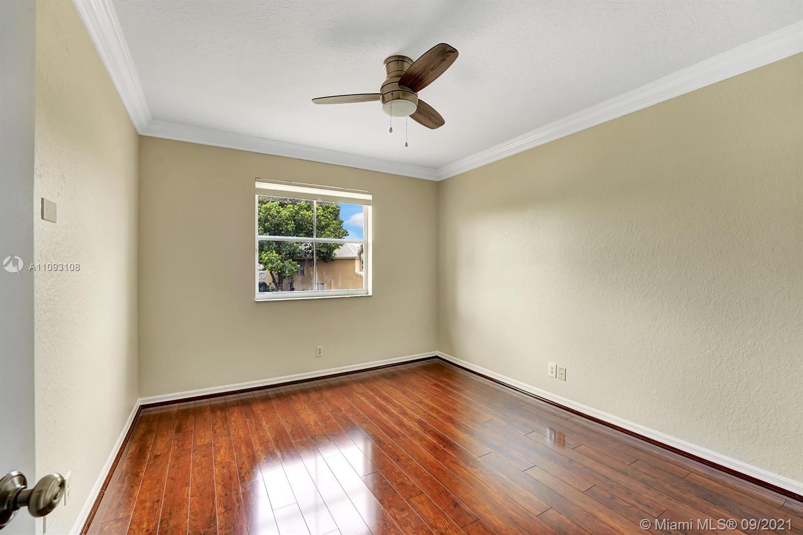 18672 Sea Turtle Lane Boca Raton, FL 33498 - Photo 23 of 44 wooden floor in an empty room with a window