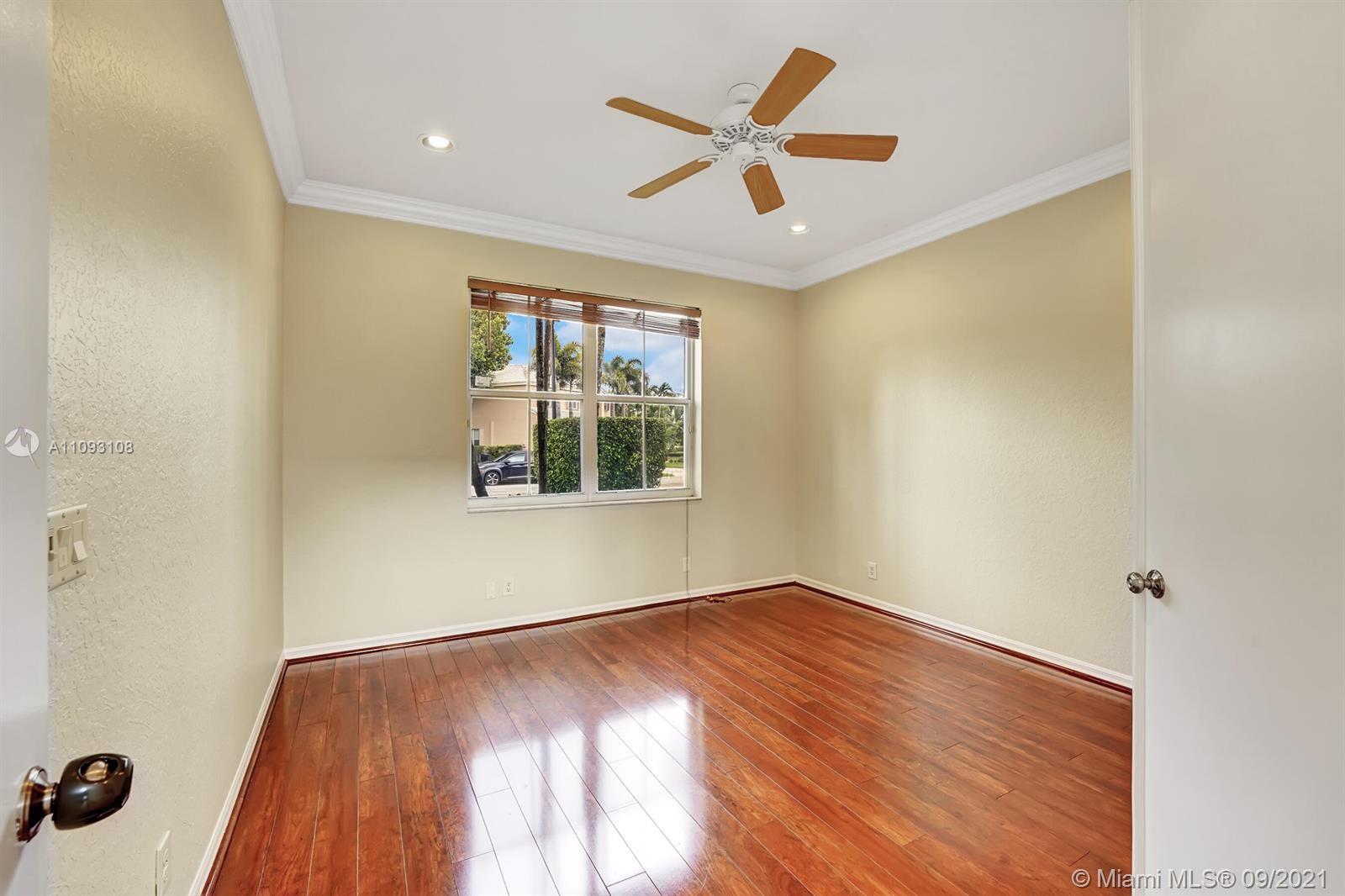 18672 Sea Turtle Lane Boca Raton, FL 33498 - Photo 24 of 44 an empty room with wooden floor and windows