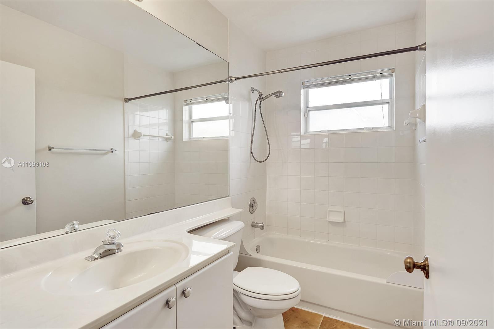 18672 Sea Turtle Lane Boca Raton, FL 33498 - Photo 26 of 44 a bathroom with a sink mirror toilet and bathtub