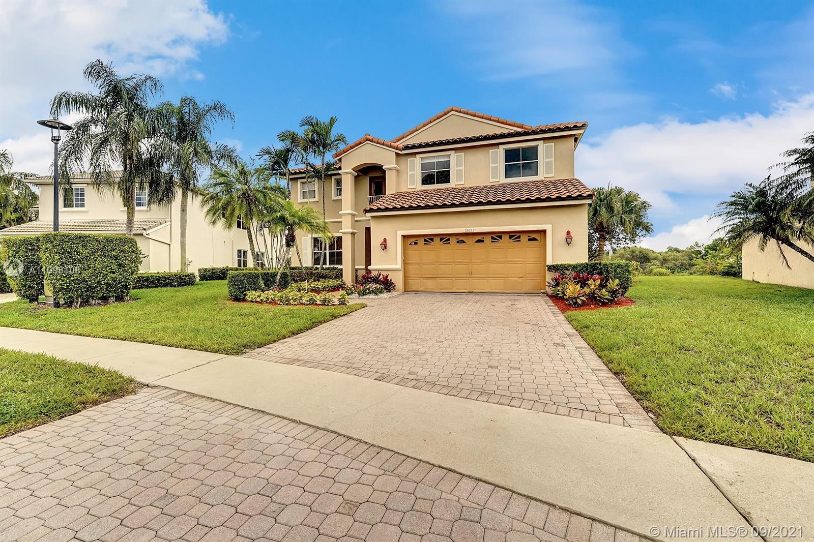 18672 Sea Turtle Lane Boca Raton, FL 33498 - Photo 31 of 44 a front view of a house with a yard