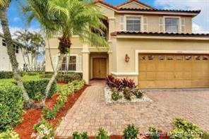 18672 Sea Turtle Lane Boca Raton, FL 33498 - Photo 32 of 44 a front view of a house with a yard