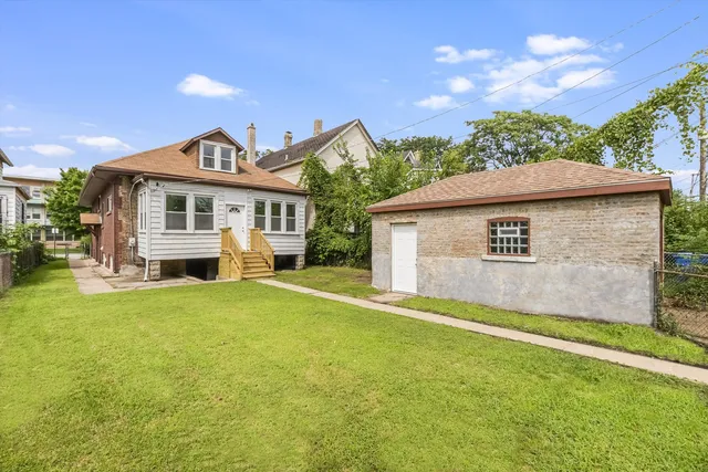 a view of a house with a yard and sitting area