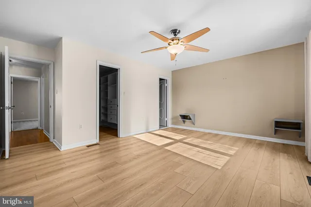 a bathroom with a granite countertop sink a toilet a shower and a mirror