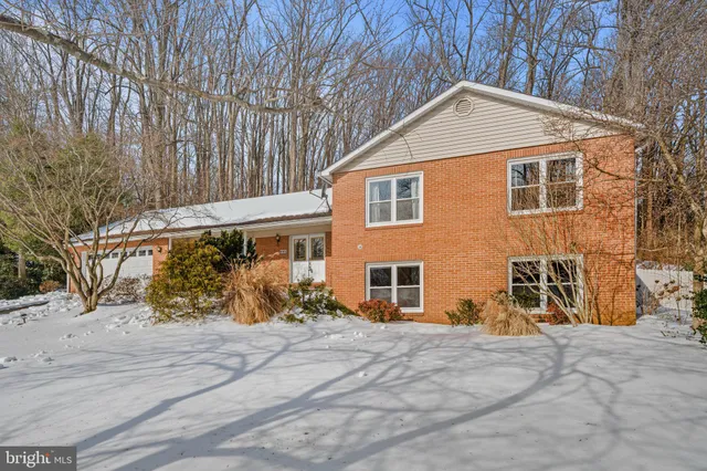 a wooden house with trees in front of it