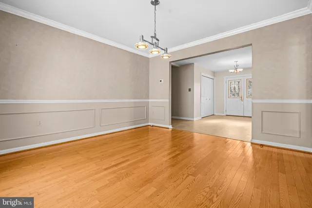 a kitchen with granite countertop a stove a sink and a refrigerator