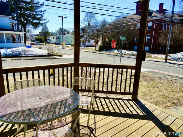 a view of a porch with wooden floor