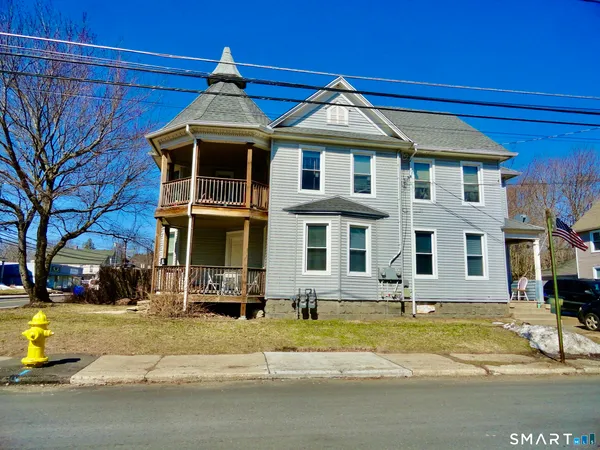 a front view of a residential apartment building with a yard