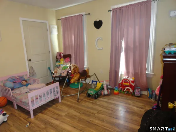 a bedroom with bed and a window