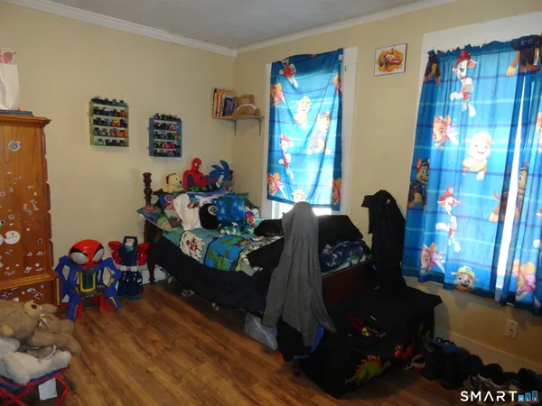 a bedroom with furniture and a window