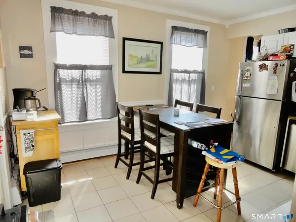 a room with furniture a refrigerator and a table