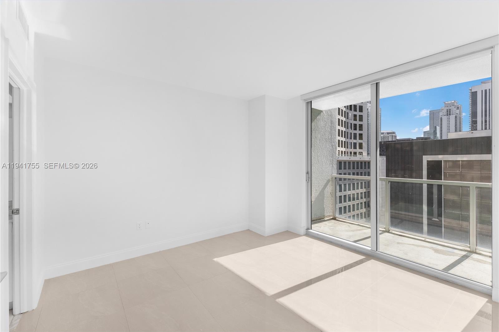 55 Southeast 6th Street, Unit 1202 Miami, FL 33131 - Photo 21 of 45 a room with a white walls and a window