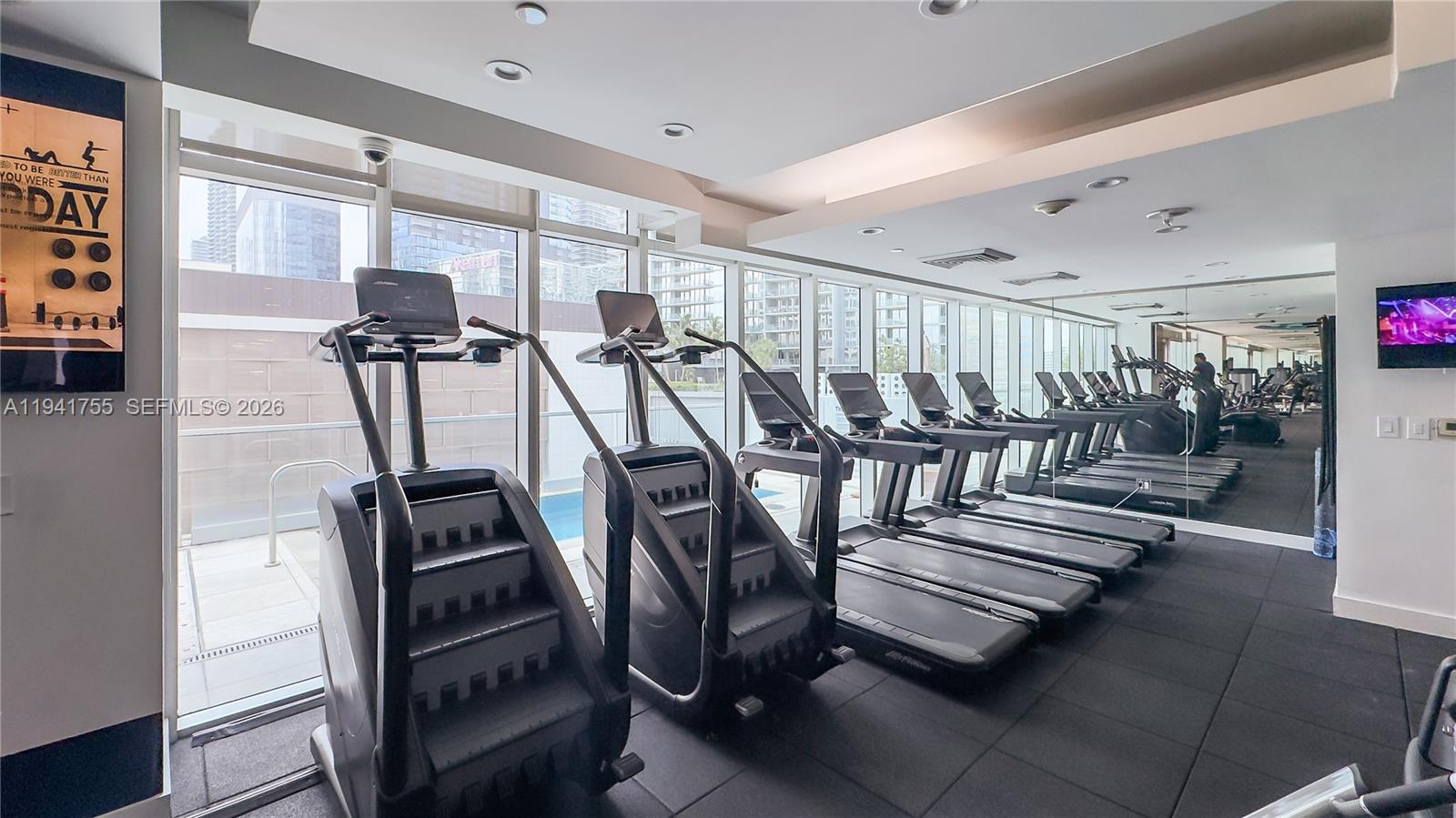 55 Southeast 6th Street, Unit 1202 Miami, FL 33131 - Photo 30 of 45 a view of a room with gym equipment