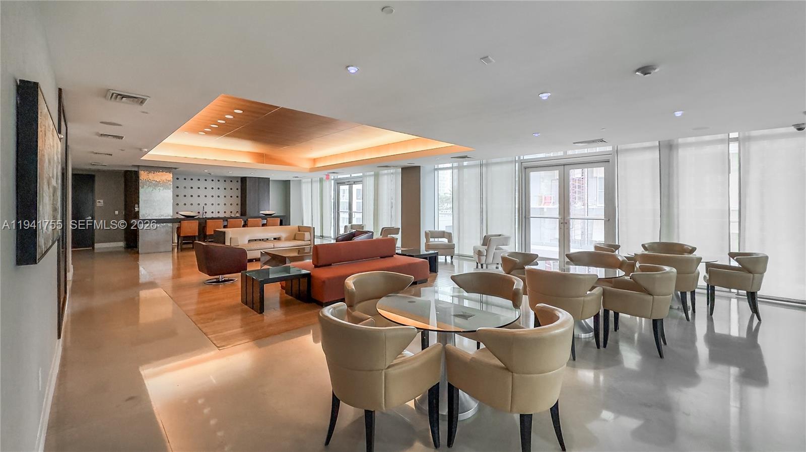 55 Southeast 6th Street, Unit 1202 Miami, FL 33131 - Photo 33 of 45 a living room with lots of furniture and a large window