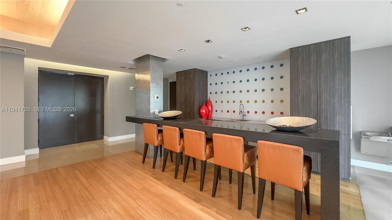 55 Southeast 6th Street, Unit 1202 Miami, FL 33131 - Photo 34 of 45 a view of a hallway with furniture and wooden floor